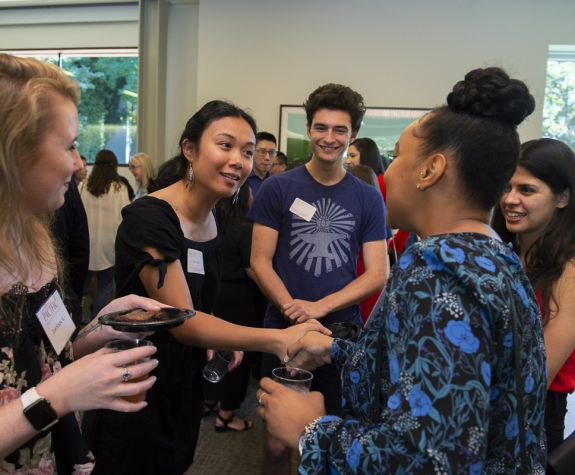 students shaking hands at event